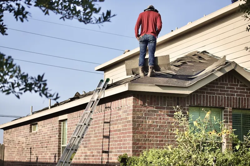 Professional roofer working on a residential roof in Shady Oaks Manor